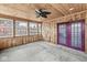 This sunroom features natural wood paneling, large windows, and a ceiling fan for a cozy atmosphere at 5465 Leone Dr, Indianapolis, IN 46226