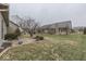 A spacious backyard featuring a patio, lawn, and mature trees offering outdoor living and landscaping opportunities at 613 Brook Dr, Greenwood, IN 46143