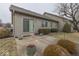The patio is surrounded by mature landscaping and greenery at 613 Brook Dr, Greenwood, IN 46143