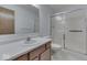 This bright bathroom has a shower and a vanity with a sink and storage at 613 Brook Dr, Greenwood, IN 46143