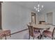 Traditional dining room with patterned walls, round table, and classic chandelier at 613 Brook Dr, Greenwood, IN 46143