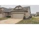 View of a cozy single-Gathering home with a two-car garage and well-manicured lawn at 613 Brook Dr, Greenwood, IN 46143
