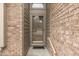 Close-up of a charming front door, complemented by a brick wall and modern sidelights at 613 Brook Dr, Greenwood, IN 46143