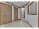 Hallway with fruit-themed wallpaper and multiple doorways leading to other rooms at 613 Brook Dr, Greenwood, IN 46143