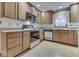 Well-lit kitchen with wooden cabinets, modern appliances, and a window above the sink at 613 Brook Dr, Greenwood, IN 46143