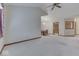 Open-concept living room with neutral carpeting, dining area, and chandelier at 613 Brook Dr, Greenwood, IN 46143