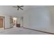Open-concept living room with neutral carpet, multiple doorways, and ample space at 613 Brook Dr, Greenwood, IN 46143