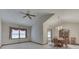 Bright living room with vaulted ceilings, neutral carpet, and dining area with chandelier at 613 Brook Dr, Greenwood, IN 46143