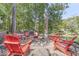 Inviting backyard with fire pit area, surrounded by red chairs, perfect for outdoor gatherings at 6420 Oriole Dr, Nineveh, IN 46164
