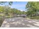 Backyard featuring concrete patio with lake view and secure fence surrounding property at 6420 Oriole Dr, Nineveh, IN 46164