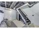 View of the basement staircase, refrigerator, and comfortable seating area at 6420 Oriole Dr, Nineveh, IN 46164