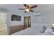 Cozy bedroom with ceiling fan, tv, dresser and ensuite bathroom with tiled shower at 6420 Oriole Dr, Nineveh, IN 46164