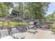 Spacious waterfront deck with lounge chairs, dining set, and boat dock perfect for lakeside enjoyment at 6420 Oriole Dr, Nineveh, IN 46164