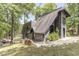 Stylish A-frame home with gray shingles, brick accents, and a landscaped yard extending to the waterfront at 6420 Oriole Dr, Nineveh, IN 46164