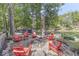 Relaxing outdoor fire pit area featuring comfortable red Adirondack chairs and views of the lake at 6420 Oriole Dr, Nineveh, IN 46164