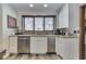 Bright kitchen featuring stainless steel appliances, granite countertops, and ample natural light from a large window at 6420 Oriole Dr, Nineveh, IN 46164