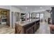 Bright kitchen with stainless steel appliances, a large island, and views of the connected dining area at 6420 Oriole Dr, Nineveh, IN 46164