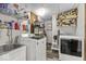 Functional laundry room with modern washer and dryer, sink, and ample storage at 6420 Oriole Dr, Nineveh, IN 46164