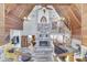 Open-concept living room featuring high ceilings, a stone fireplace, and a spiral staircase to the upper level at 6420 Oriole Dr, Nineveh, IN 46164