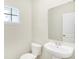 Powder room featuring a pedestal sink, toilet, and a framed mirror at 7161 Jackson Dr, Cumberland, IN 46229