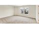 Bedroom with neutral carpet, white walls, and neighborhood view at 7161 Jackson Dr, Cumberland, IN 46229