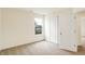Empty bedroom featuring neutral carpet, a double door closet, and a window overlooking the property's exterior at 7161 Jackson Dr, Cumberland, IN 46229
