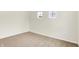 Neutral bedroom featuring plush carpet, bright windows, and an electrical outlet at 7161 Jackson Dr, Cumberland, IN 46229
