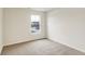 A spacious bedroom with carpet floors and a large window that allows for natural lighting at 7161 Jackson Dr, Cumberland, IN 46229