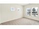 Cozy bedroom with neutral carpet, bright windows, and ample natural light at 7161 Jackson Dr, Cumberland, IN 46229