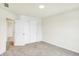 Well-lit bedroom featuring a closet with sliding doors, a ceiling light, and carpeted floors at 7161 Jackson Dr, Cumberland, IN 46229