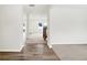 Bright entryway with hardwood floors transitioning to carpeted living area, showcasing an open floor plan at 7161 Jackson Dr, Cumberland, IN 46229