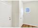 Hallway with a small window with a view and white doors, hardware and walls at 7161 Jackson Dr, Cumberland, IN 46229
