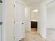 Hallway with neutral paint, carpet floors, and a view of a vanity in the bathroom at 7161 Jackson Dr, Cumberland, IN 46229