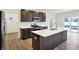 Stylish kitchen featuring a central island, stainless steel appliances, and access to the backyard at 7161 Jackson Dr, Cumberland, IN 46229