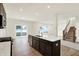 Open kitchen with a central island, hardwood floors, and stainless steel dishwasher at 7161 Jackson Dr, Cumberland, IN 46229