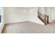 Inviting living room with neutral carpet, adjacent to a staircase and featuring hardwood flooring at 7161 Jackson Dr, Cumberland, IN 46229