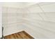 Walk-in pantry with wire shelving and laminate flooring for organized storage at 7161 Jackson Dr, Cumberland, IN 46229