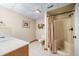 Well-lit bathroom with a tile shower, modern vanity, decorative wall art, and a stylish, patterned ceiling at 8221 Mcwhorter Rd, Martinsville, IN 46151