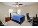 Bedroom with a blue bed, wood nightstand, carpeted floors, and a ceiling fan at 9506 Oakley Dr, Indianapolis, IN 46260