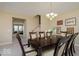 Inviting dining room with a dark wood table set for six, complemented by stylish decor at 9506 Oakley Dr, Indianapolis, IN 46260