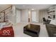 Spacious living room with carpet, stairs to the next level, and neutral walls at 9506 Oakley Dr, Indianapolis, IN 46260