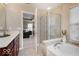Luxurious bathroom featuring a soaking tub, separate shower, and elegant vanity area at 9506 Oakley Dr, Indianapolis, IN 46260