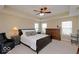 Spacious main bedroom with tray ceilings, neutral decor, and ample natural light from the windows at 9506 Oakley Dr, Indianapolis, IN 46260