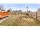 Expansive backyard with a wooden privacy fence, and an adjacent deck on the side at 10156 Park Royale Dr, Indianapolis, IN 46229