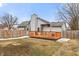 View of the backyard with an orange deck with outdoor seating and a fenced in yard at 10156 Park Royale Dr, Indianapolis, IN 46229