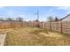 Large backyard with a wooden fence, providing privacy and ample space for outdoor activities at 10156 Park Royale Dr, Indianapolis, IN 46229