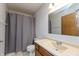 Bathroom features a vanity with a single sink, neutral countertop, and a shower with a curtain at 10156 Park Royale Dr, Indianapolis, IN 46229