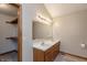 Well-lit bathroom with double sinks, a large mirror, and storage beneath the countertop at 10156 Park Royale Dr, Indianapolis, IN 46229