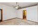 A bright and airy bedroom features neutral carpet and a ceiling fan for added comfort at 10156 Park Royale Dr, Indianapolis, IN 46229