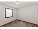 Bright bedroom with natural light, textured ceiling, carpeted floor and baseboard trim at 10156 Park Royale Dr, Indianapolis, IN 46229